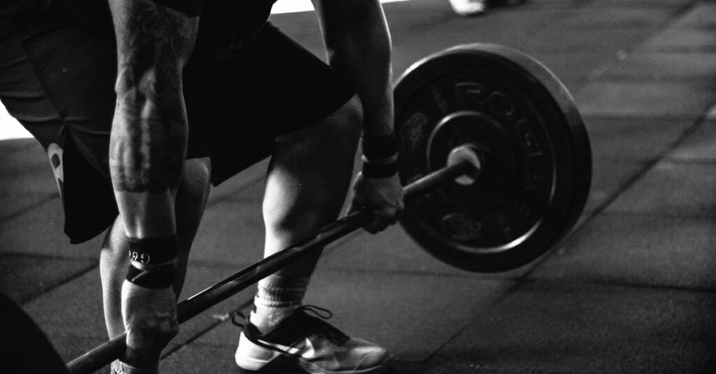 A powerful black and white image of a man deadlifting in a gym, showcasing strength and fitness.